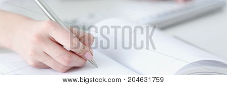 Female Hand Holding Silver Pen Ready To Make Note