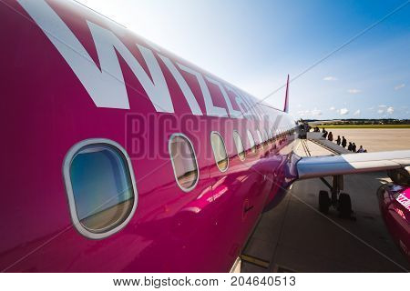 Gdansk Poland August 24 2017: People are boarding to the aircraft of Wizz Air at the airport of Lech Walesa