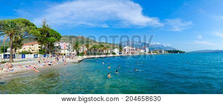 TIVAT MONTENEGRO - SEPTEMBER 10 2017: Unknown people rest on beach of popular resort town of Tivat Montenegro