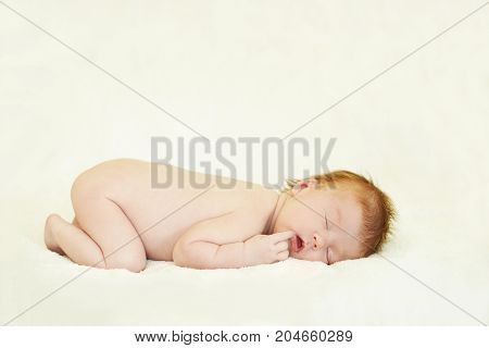 Sleep little newborn girl. Finger on month