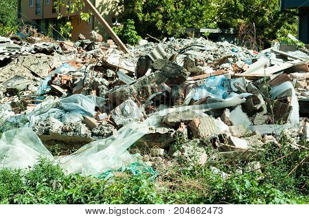 Remains of old ruined house on the place where will be new residential building