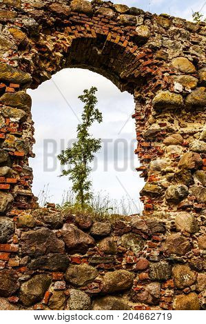 very old Kazdangas church wall of stones.