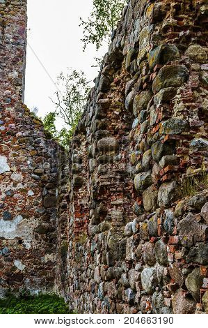 very old Kazdangas church wall of stones.