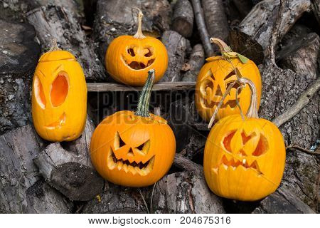 Halloween Themes. Composition Of Five Carved Halloween Pumpkins On Wooden Background. Pumpkins With