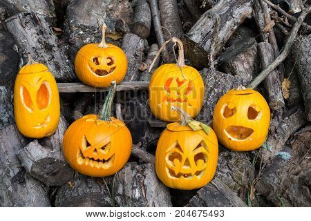 Halloween Themes. Composition Of Six Carved Halloween Pumpkins On Wooden Background. Pumpkins With D