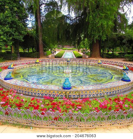 a magnificent foutain garden of la cruz ( seville spain )