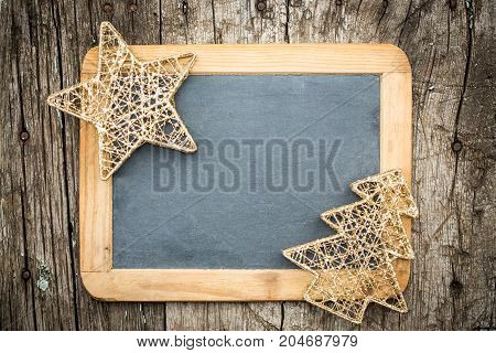 Gold Christmas Tree Decorations On Vintage Wooden Blackboard