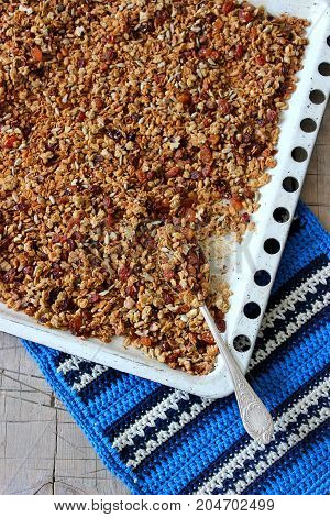 Home granola on a white baking sheet. Rustic style, selective focus.