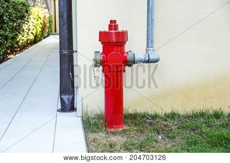 Old red fire hydrant in the street. Fire hidrant for emergency fire access .