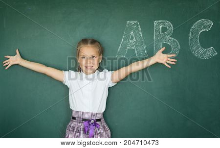Portrait Of Caucasian Happy Child Girl With. School Chalkboard Or Blackboard Background. Education C