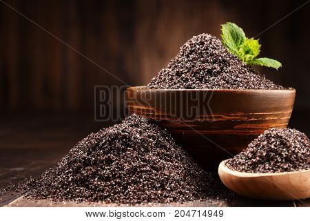 Composition With Bowl Of Poppy Seeds On Wooden Table