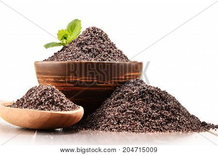 Bowl Of Poppy Seeds On White Background