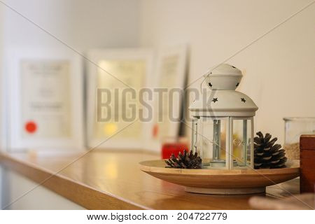 A candle lanterns and some certifications in a clinic