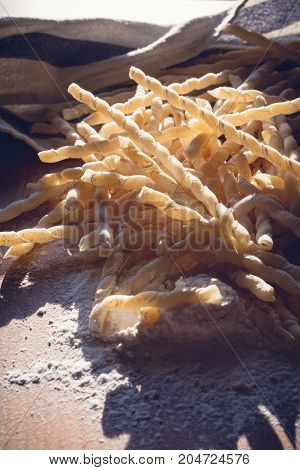 Homemade pasta lying on a wood cutting board