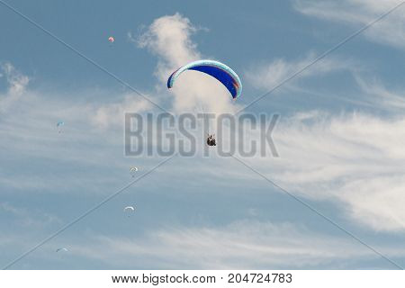 A para-glider up in the sky during a fly surrounded by the clouds