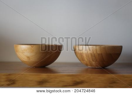 Two wooden bowls on a shelf in a clinic