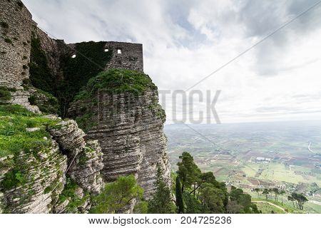Castle dedicated to goddess Venus on Erice mountain. In the background the plan of Trapani