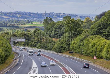 Moderate traffic on a highway between the forests in NormandyFrance.