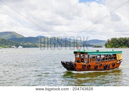 HONG KONG - JULY 14 2017: A converted fishing trawler carries passengers to outlying islands in the Sai Kung peninsula. The village of Sai Kung is also noted locally for its seafood restaurants and floating fish market.