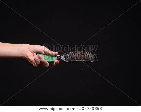 The problem of hair loss in women. Isolated on black background