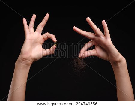 The problem of hair loss in women. Isolated on black background
