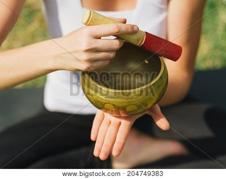 Close-up image of body parts girl's meditation at the health club outside with personal trainer, learning the correct form.