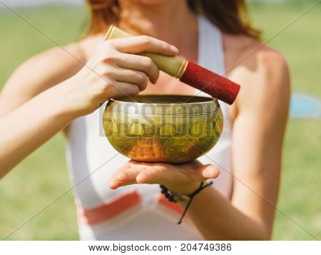 Close-up image of body parts girl's meditation at the health club outside with personal trainer, learning the correct form.