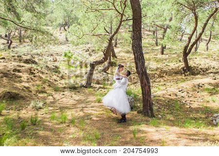 Just married couple embraced on nature. Bride and groom.