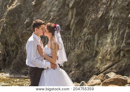 Romantic dating. Young loving couple walking together by the beach enjoying sea.