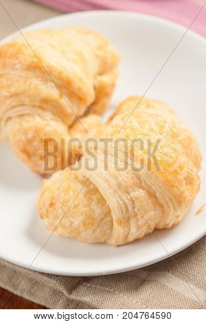 Croissant pastry on dish - Stock Image