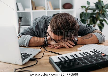Overworked Musician Sleeping At Workplace