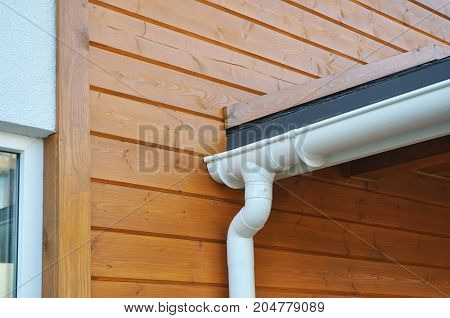Closeup of problem areas for white rain gutter waterproofing. Roof gutter waterproofing. House Rain gutter repair