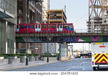 London England - August 13 2017: Overground DLR train approaches Canary Wharf DLR station in London Stock Exchange district.