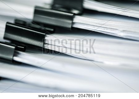 extreamely close up the report paper stacking of office working document with paper clip folder