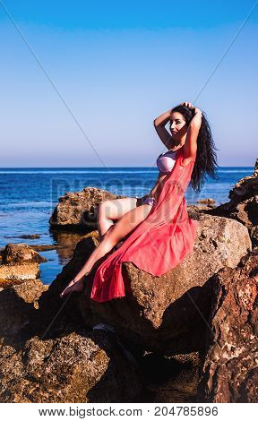 Sexy curvy brunette woman on a beach