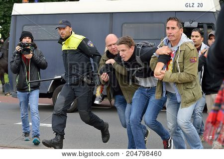 ENSCHEDE THE NETHERLANDS - SEPT 17 2017: A man is being arrested during an anti-islam demonstration of Pegida. His goal was to disturb the protest.