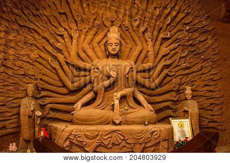 Buddha statue in Leshan,China. Sichuan Province. Woman in a rock with her hands
