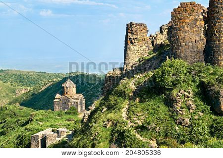 View of a part of an ancient fortress Amberd in Armenia with a medieval cathedral on the background