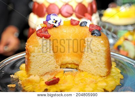 close up orange cake and berry on top