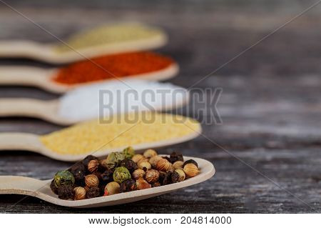 Various Colorful Spices On Wooden Table