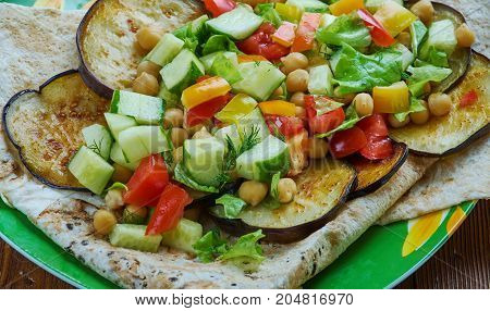Mediterranean chickpea salad with za'atar and eggplant , close up meal