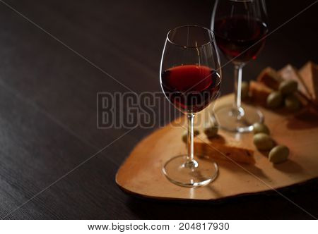 Wineglasses With Red Wine On Wood With Cheese And Green Olives - With Space For Text
