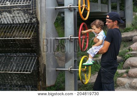 Warsaw, Poland - August 2, 2017: Dad And His Son Spend Time In The City Park.
