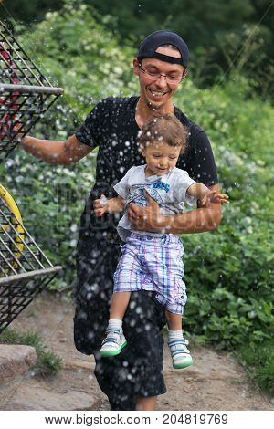 Warsaw, Poland - August 2, 2017: Dad And His Son Spend Time In The City Park.