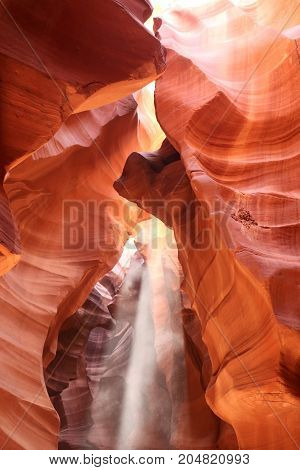 Rays of light illuminating red sandstone cave in Upper Antelope Slot Canyon Page Arizona USA. Navajo land. Amazing nature background.