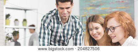 Young and energetic team of co-workers in creative start-up company