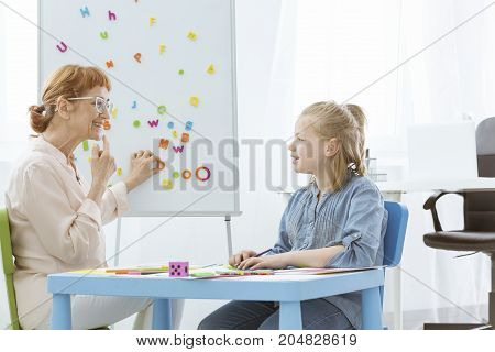 Speech Teacher Practicing With Girl