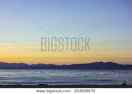 Sunset or blue hour in quiet beach of l'Escala, Costa Brava, Spain. Mediterranean Sea