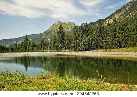 Mount Aggenstein in Tyrol Austria with storage pond