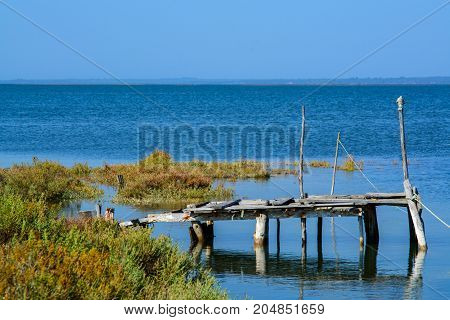 abandoned old fishing dock lin calm water in comporta alentejo Portugal.